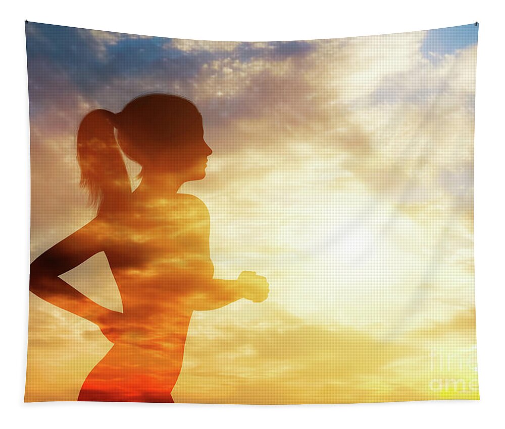 Woman Tapestry featuring the photograph Silhouette of a running woman on sky background. by Michal Bednarek