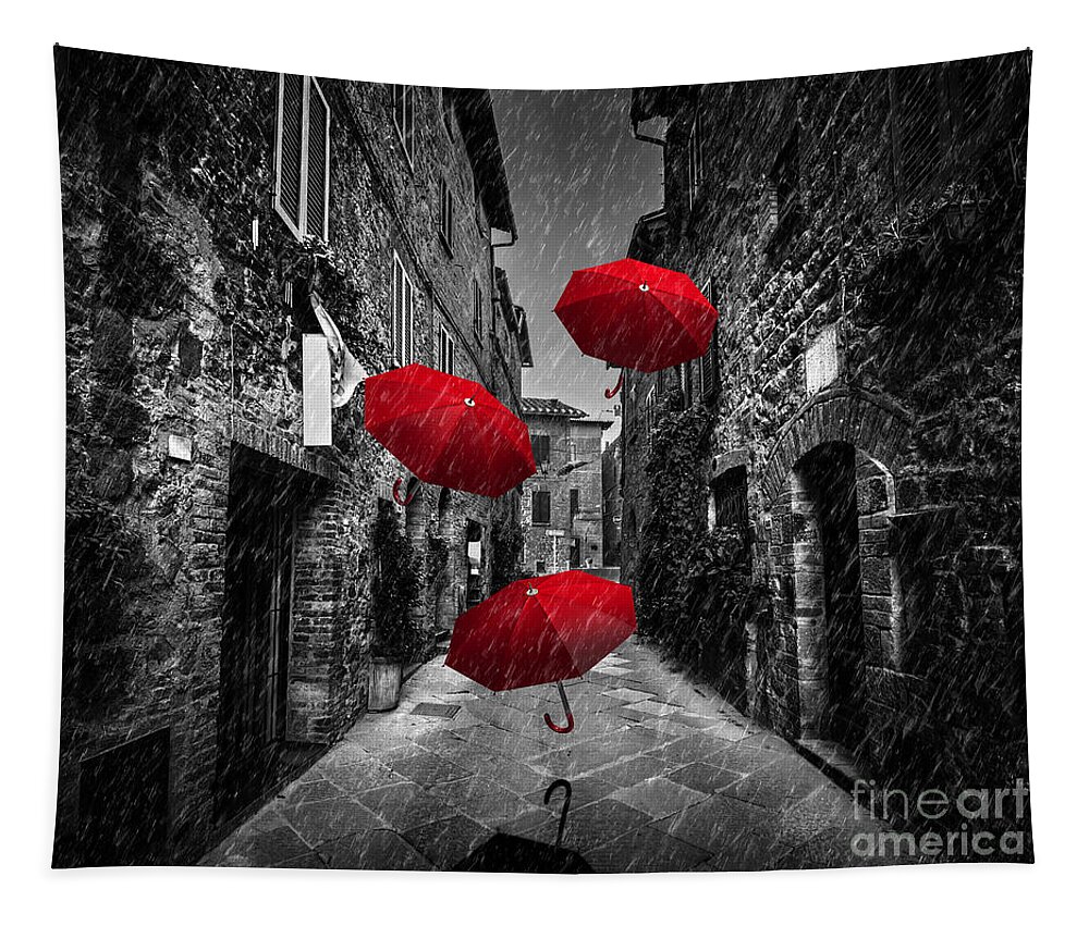 Italian Tapestry featuring the photograph Umrbellas flying with wind and rain on dark street in an old Italian town in Tuscany, Italy by Michal Bednarek