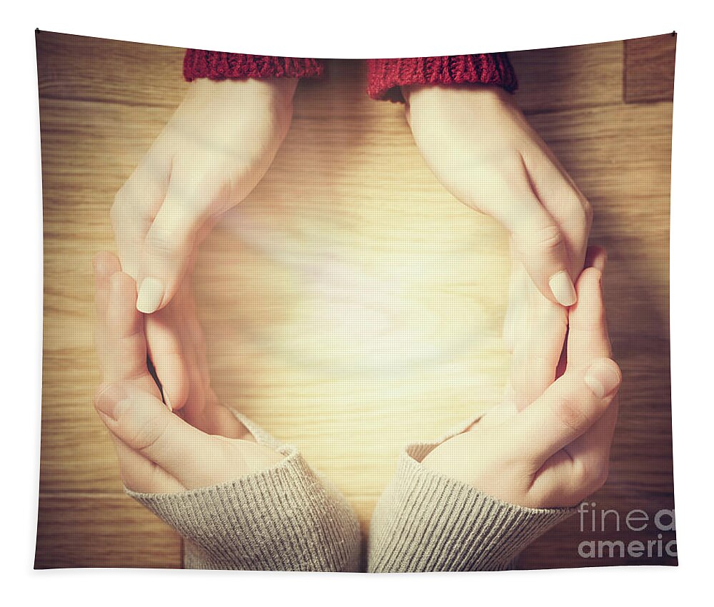 Hands Tapestry featuring the photograph Woman and man making circle with hands. Warm light inside by Michal Bednarek