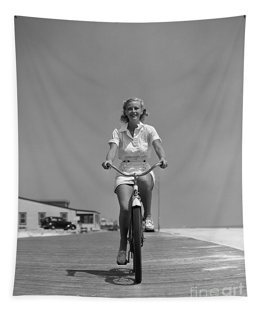 1940s Tapestry featuring the photograph Woman Riding Bike On Boardwalk, C.1940s by H. Armstrong Roberts/ClassicStock