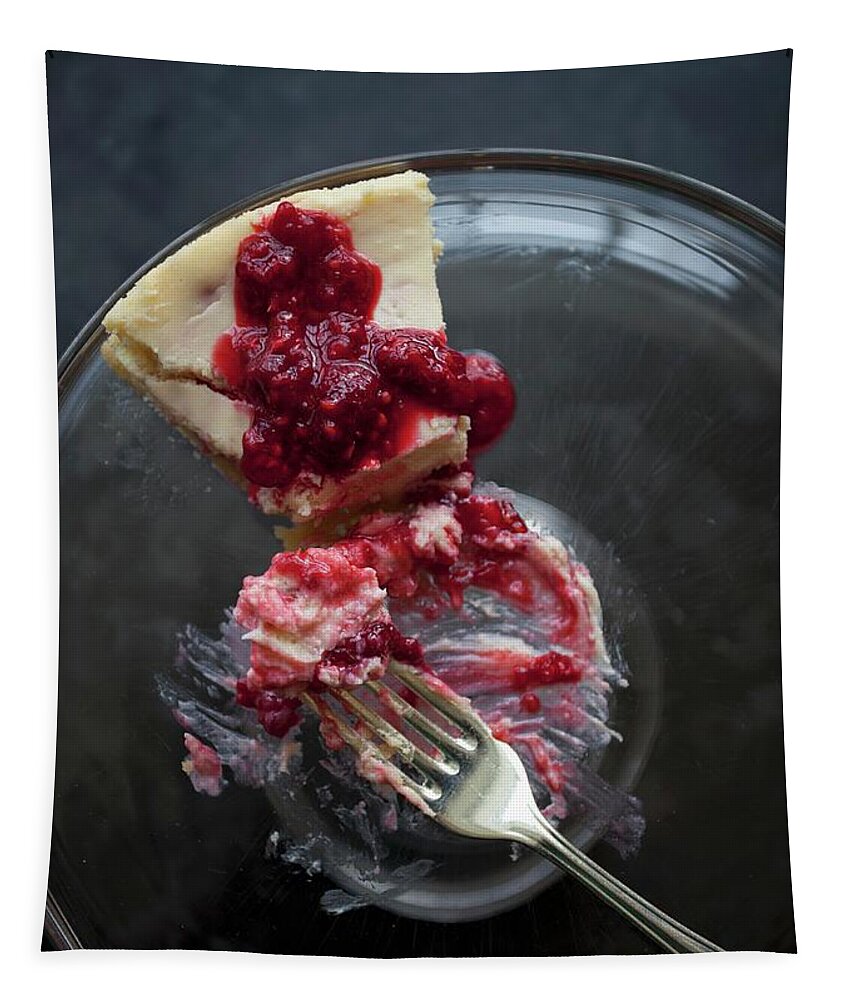 Ip_11343074 Tapestry featuring the photograph A Slice Of Cheesecake With Raspberry Sauce On A Glass Plate With A Fork With A Bite Taken Out by Ryla Campbell