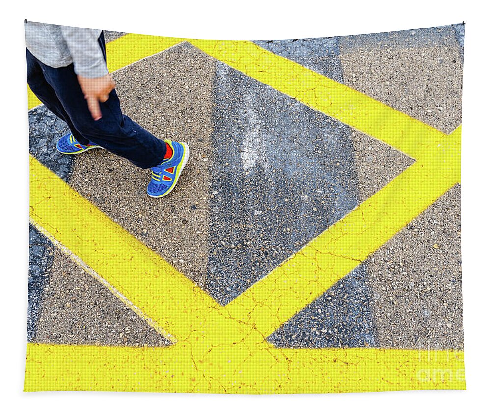 Asphalt Tapestry featuring the photograph Child's legs on yellow lines on asphalt. by Joaquin Corbalan