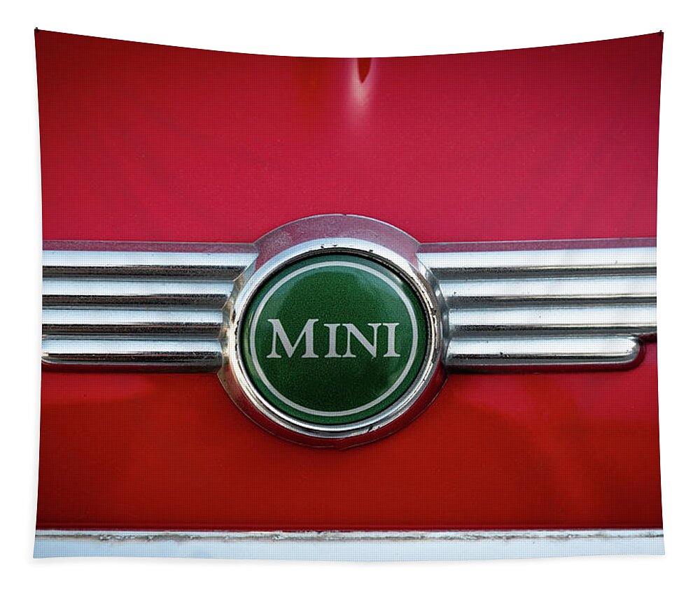 Mini Tapestry featuring the photograph Mini Cooper car logo on red surface by Michalakis Ppalis