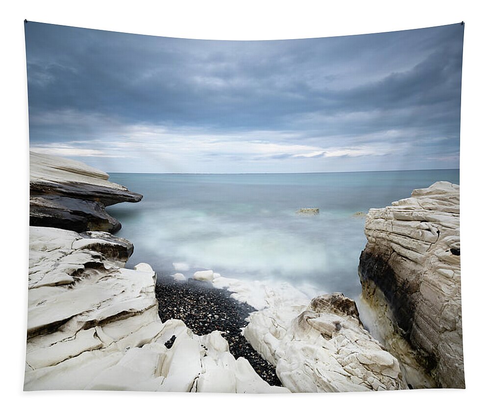 Seascape Tapestry featuring the photograph Rocky coast with white limestones and cloudy sky by Michalakis Ppalis