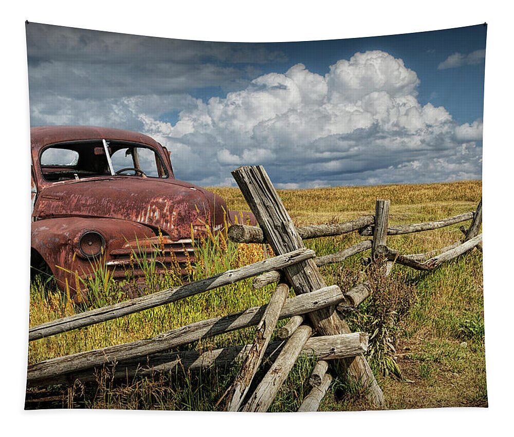 Automobile Tapestry featuring the photograph Rusted Vintage Automobile in a Rural Landscape behind Old Wooden Log Fence by Randy Nyhof