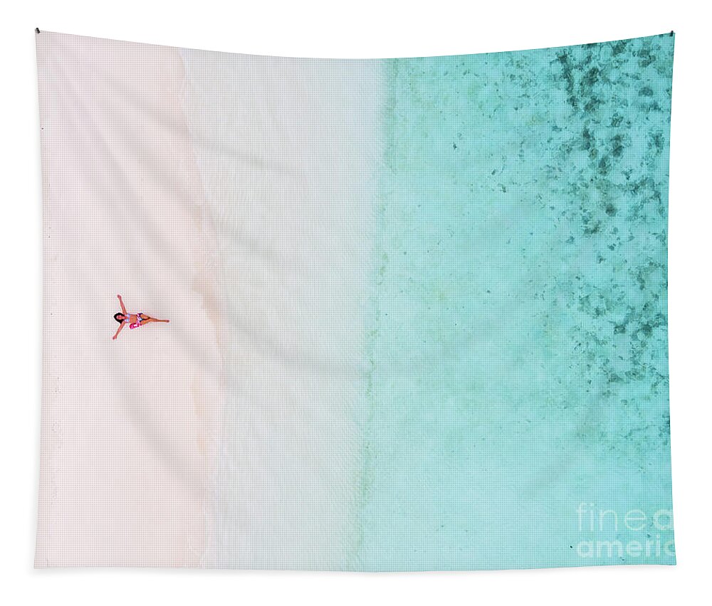 Woman Tapestry featuring the photograph Woman relaxing on beach, aerial view, Maldives by Matteo Colombo