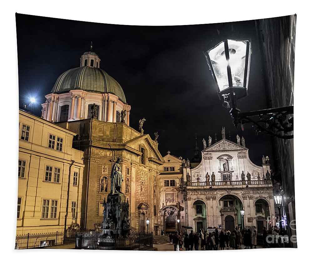 Prague Tapestry featuring the photograph Historic Buildings Beneath The Tower Of Charles Bridge In The Night In Prague In The Czech Republic #1 by Andreas Berthold