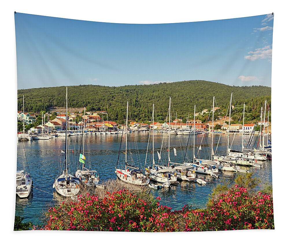 Fiscardo Tapestry featuring the photograph The port of Fiskardo in Kefalonia, Greece #1 by Constantinos Iliopoulos