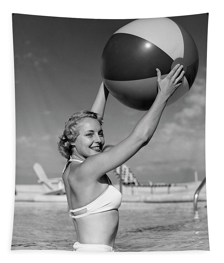 B&w Black And White 1950s Adults Adult Air Ball Beach Bikini Blond Blonde Copy Space Eye Contact Fashion Female Females Figure Fun Half-length Happiness Happy Healthiness Holding Leisure Looking At Camera Outdoors People Person Pool Portraits Portrait Recreation Swimming Recreation Side Smile Smiles Smiling Standing Stylish Swimming Swimming Pool View Waist-high Water White Woman Women Young Adult Woman Young Adult Retro Vintage Nostalgia Nostalgic Old Fashioned Old Fashion Old Time Classic Tapestry featuring the photograph 1950s Side View Of Blonde In White Bikini Standing In Pool In Waist-high Water Holding Beach Ball In by Panoramic Images