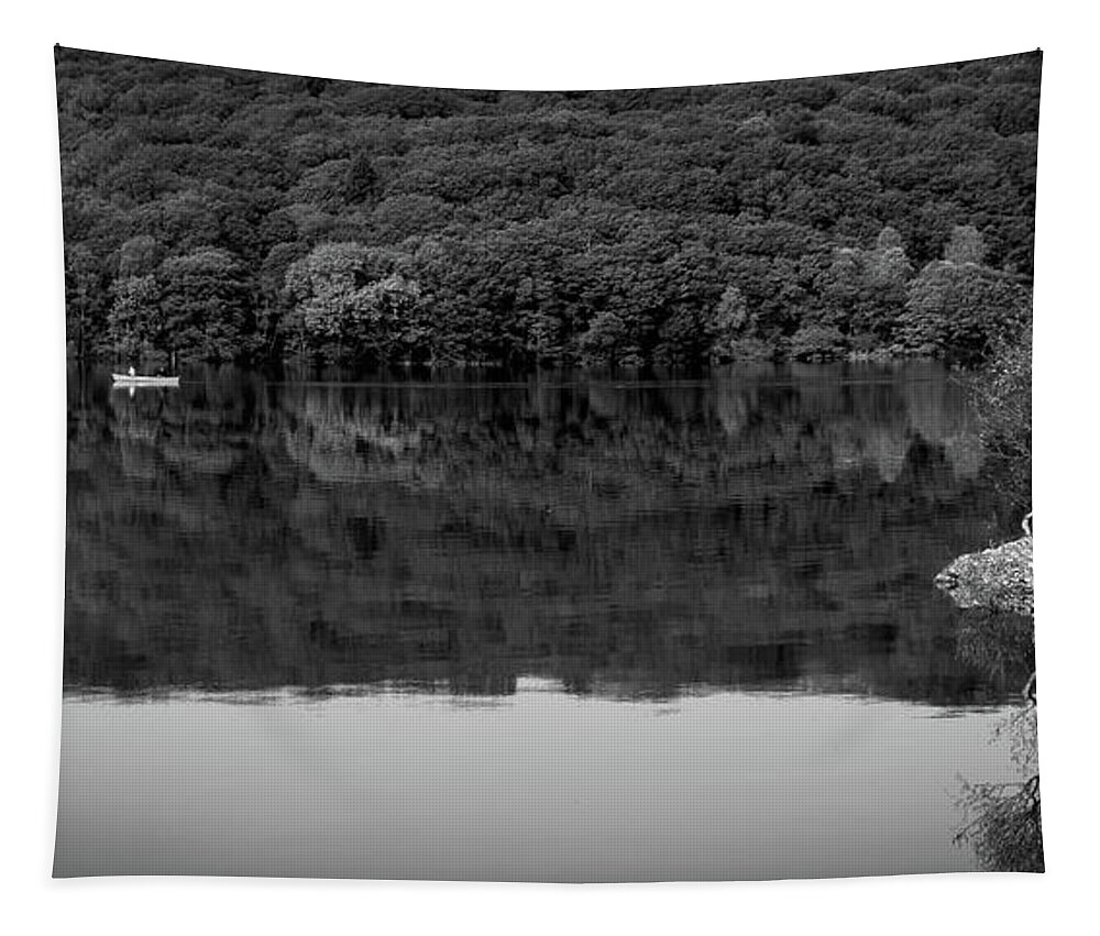 Britain Tapestry featuring the photograph A couple pass in a canoe on Coniston Water by Seeables Visual Arts
