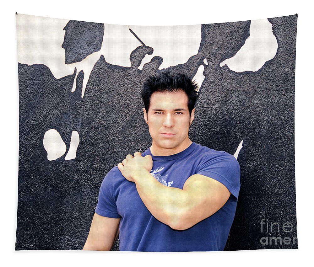 Young Tapestry featuring the photograph A handsome muscular man poses in front of a cigar store. by Gunther Allen