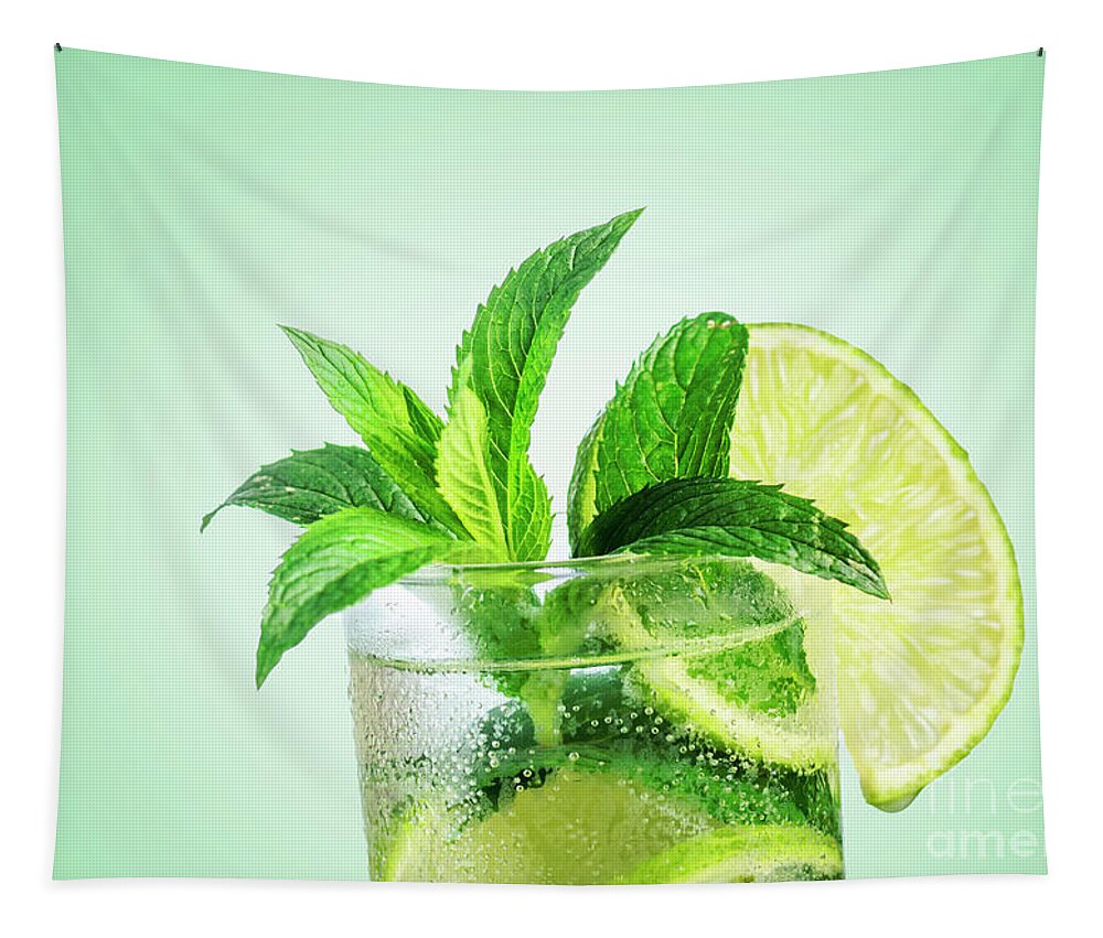 Mojito Tapestry featuring the photograph Closeup mojito cocktail with ice isolated over pastel background by Jelena Jovanovic