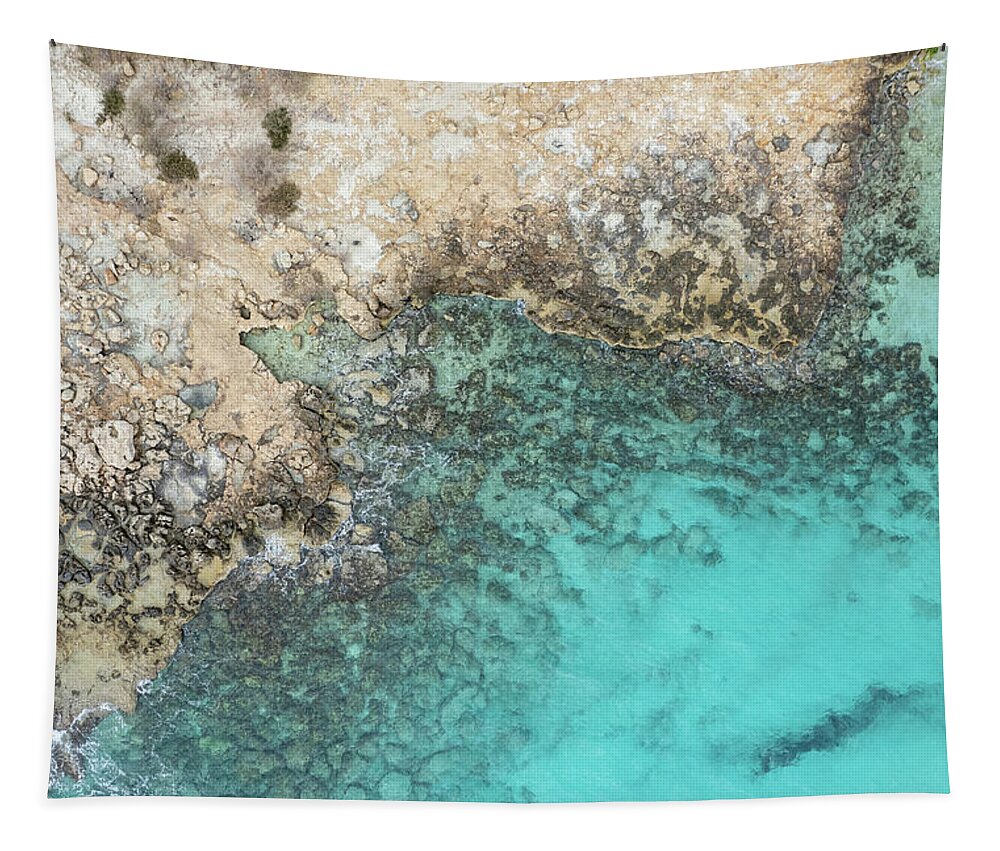 Rocky Beach Tapestry featuring the photograph Drone aerial of rocky sea coast with transparent turquoise water. Seascape top view by Michalakis Ppalis