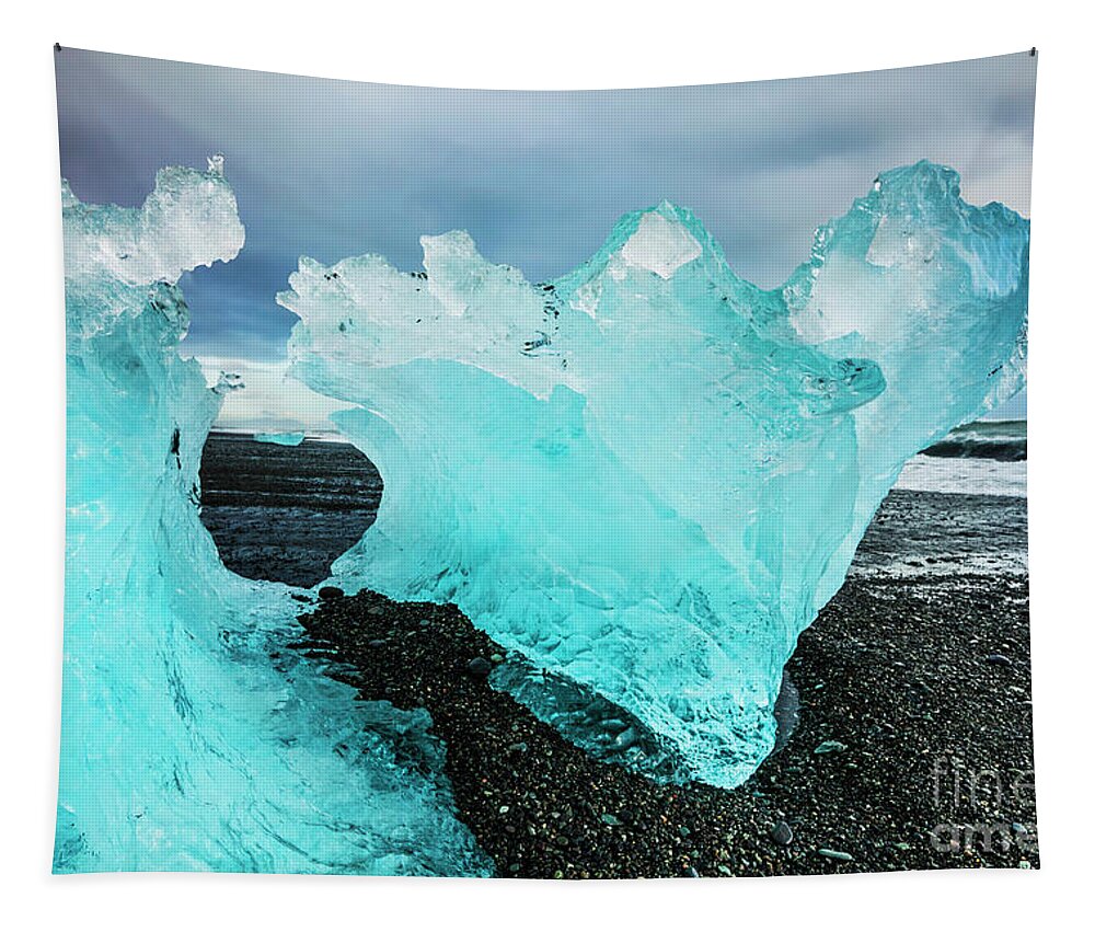 Diamond Beach Tapestry featuring the photograph Icebergs on Jokulsarlon black beach, Iceland by Neale And Judith Clark