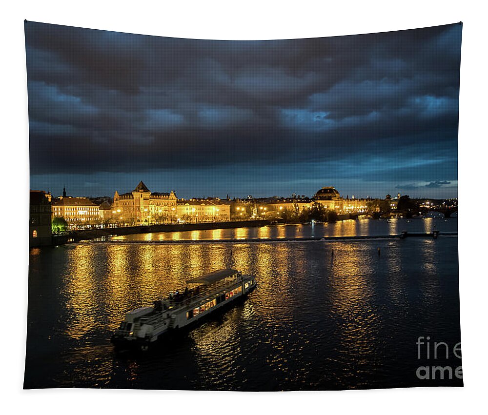 Architecture Tapestry featuring the photograph Illuminated Moldova River With Ship And Buildings In The Night In Prague In The Czech Republic by Andreas Berthold