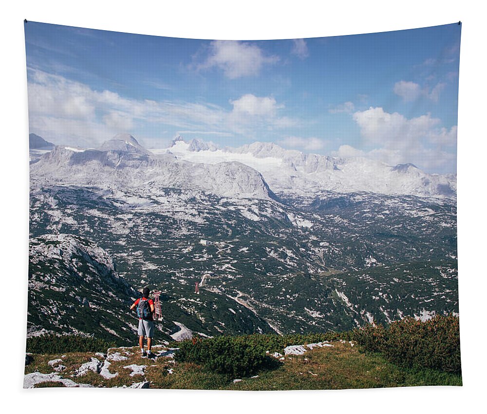 Sportive Tapestry featuring the photograph Man with a backpack looks at the Dachstein massif by Vaclav Sonnek
