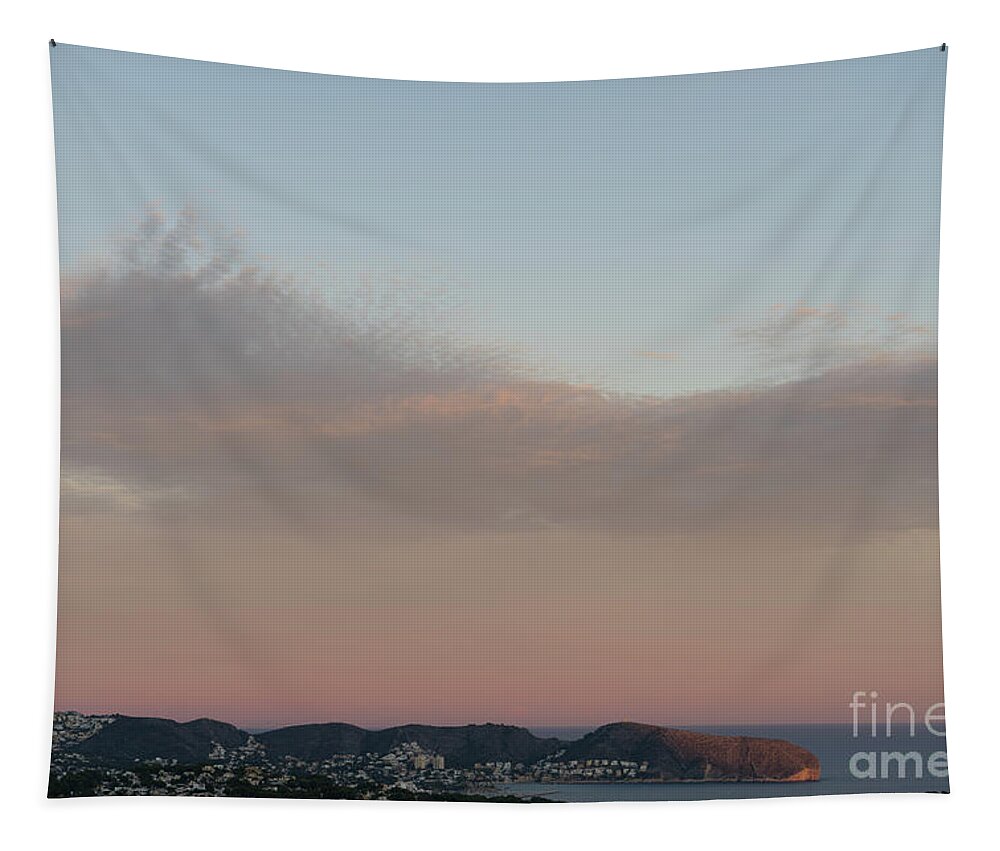 Mediterranean Coast Tapestry featuring the photograph Pale pink sky and soft clouds at sunset on the Mediterranean coast by Adriana Mueller
