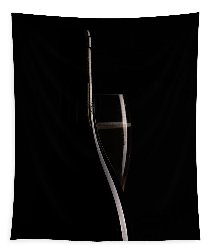 Red Wine Tapestry featuring the photograph Red sparking wine on a wineglass and black wine bottle. by Michalakis Ppalis
