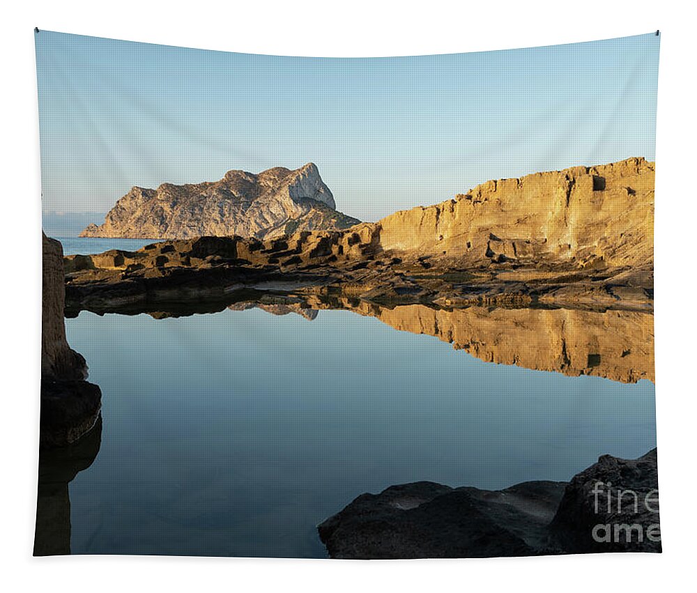 Mediterranean Tapestry featuring the photograph Reflection of rocks in the calm Mediterranean Sea at sunrise 3 by Adriana Mueller
