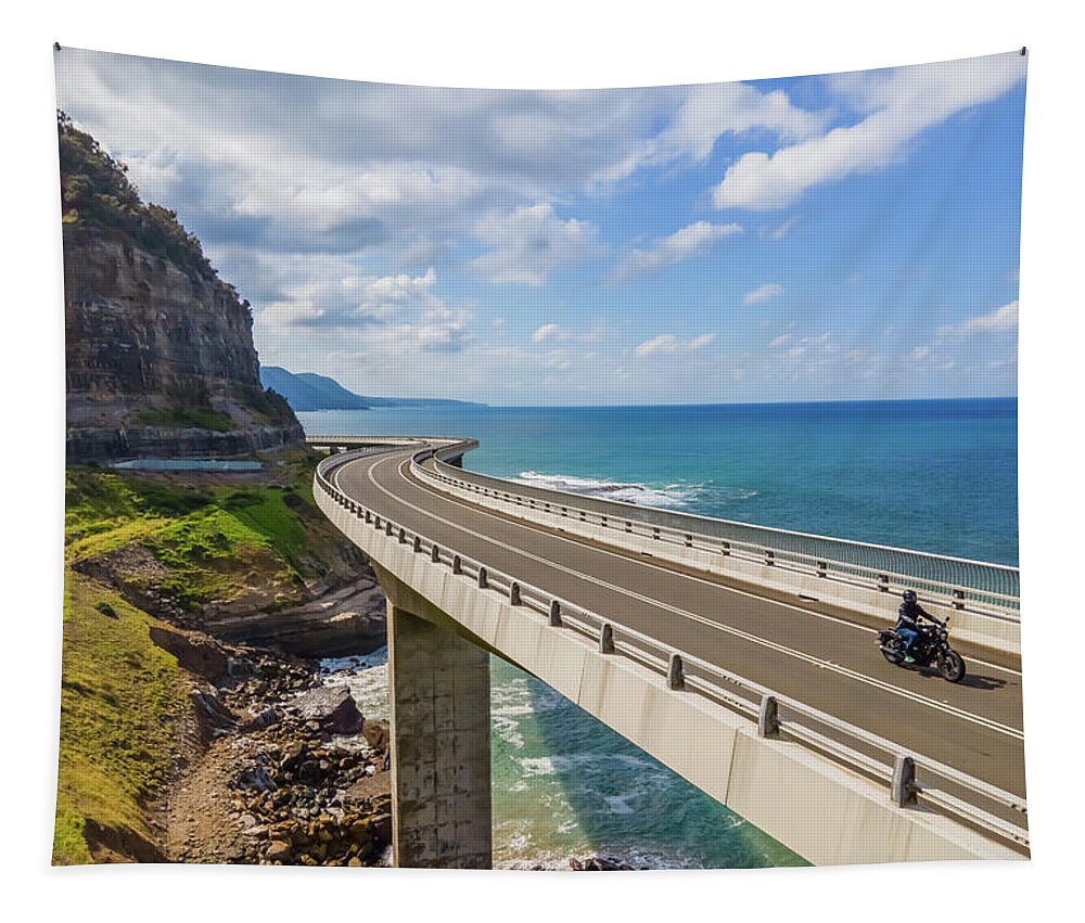 Bridge Tapestry featuring the photograph Sea Cliff Bridge and a Lone Biker by Andre Petrov