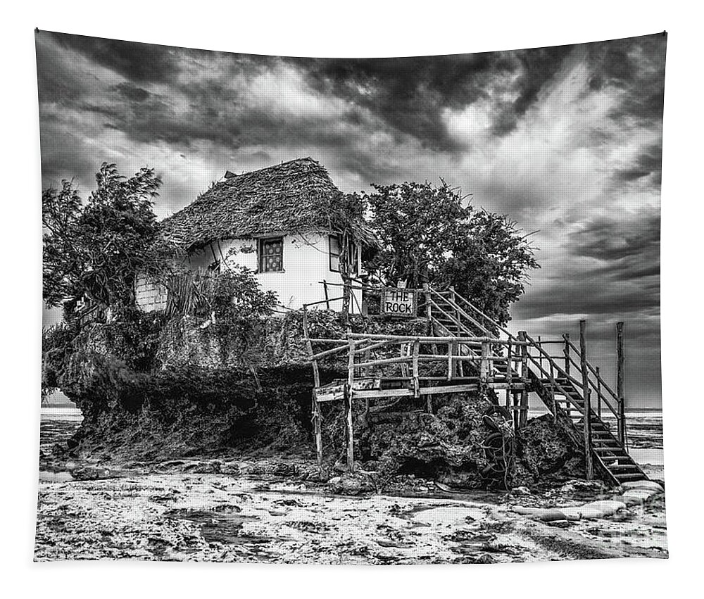 Bungalow Tapestry featuring the photograph The Rock, Zanzibar black and white by Lyl Dil Creations