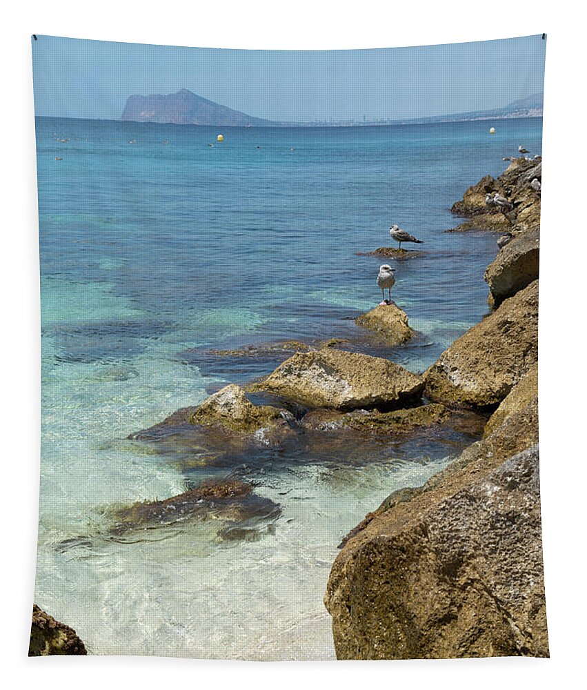 Mediterranean Tapestry featuring the photograph Turquoise blue sea water and rocks in Calpe 2 by Adriana Mueller