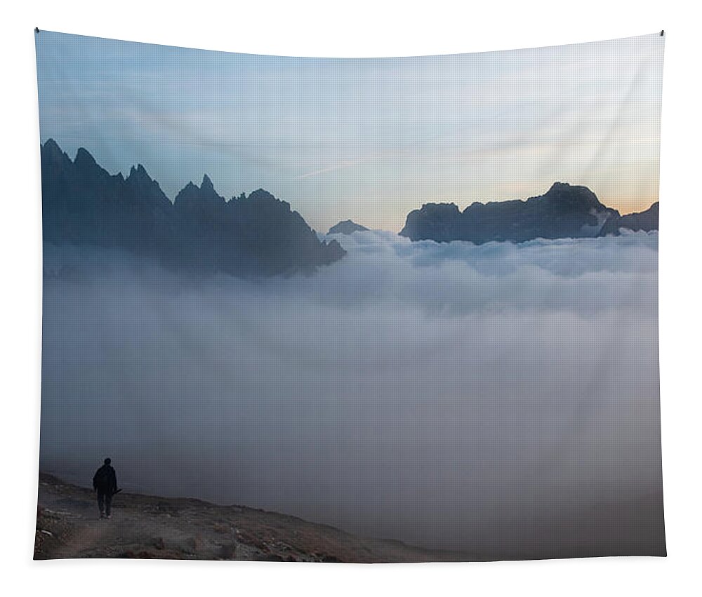 Italian Alps Tapestry featuring the photograph Unrecognized man trekking at the hiking path at Tre Cime in South Tyrol in Italy. by Michalakis Ppalis