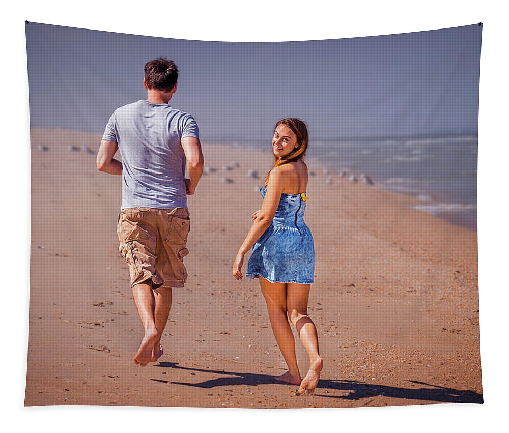 Young Tapestry featuring the photograph Young couple running on Sandy Hook Beach, New Jersey, USA. by Alexander Image