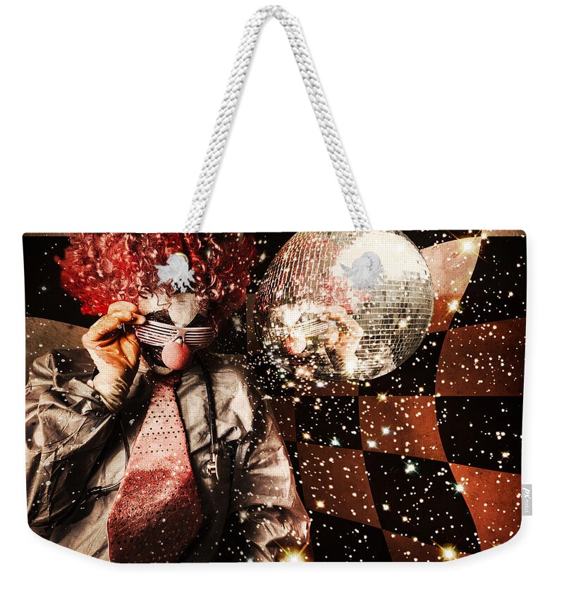 Crazy Weekender Tote Bag featuring the photograph 70s DJ clown spinning a nightclub turntable #1 by Jorgo Photography