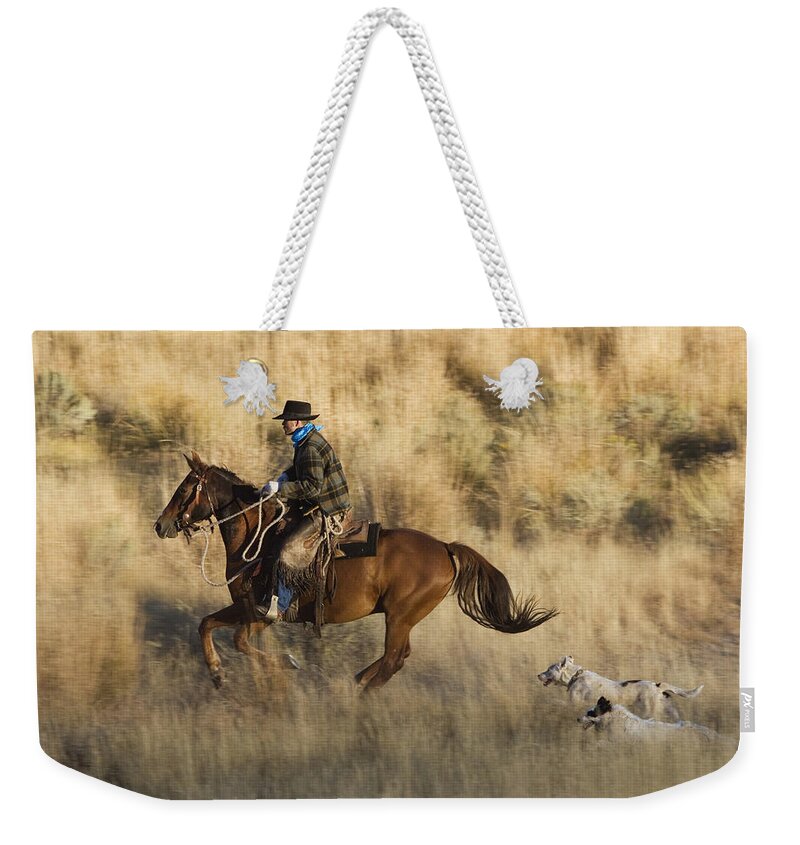 Feb0514 Weekender Tote Bag featuring the photograph Cowboy Riding With Dogs Oregon #1 by Konrad Wothe