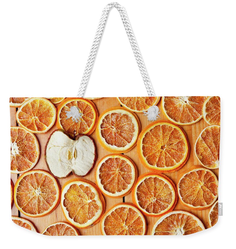 Orange Weekender Tote Bag featuring the photograph Dried Orange And Apple Slices #1 by Nils Hendrik Mueller