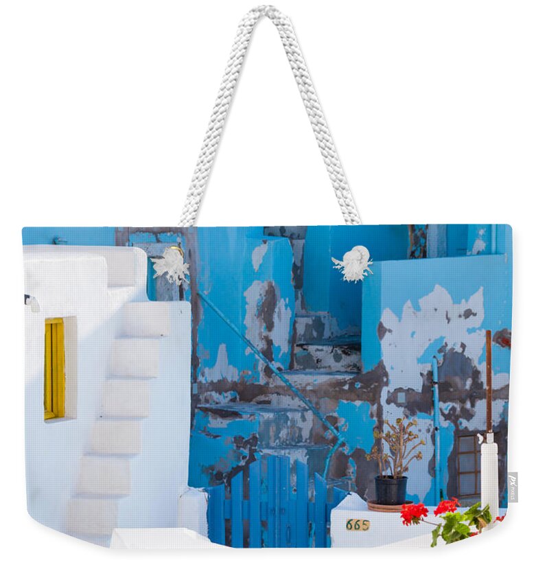 Glimpse Weekender Tote Bag featuring the photograph Glimpse of typical white houses in Oia Santorini Greece #1 by Matteo Colombo