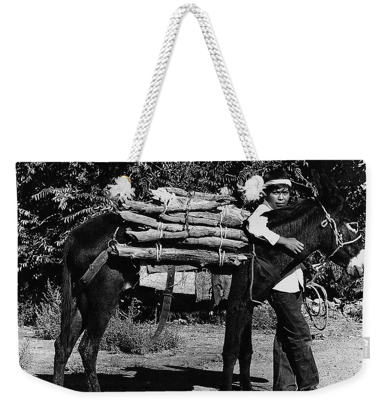Navajo Boy Donkey Carrying Wood Inter-tribal Indian Rodeo Gallup New Mexico 1969. Weekender Tote Bag featuring the photograph Navajo Boy Donkey Carrying Wood Inter-Tribal Indian Rodeo Gallup New Mexico 1969. #1 by David Lee Guss