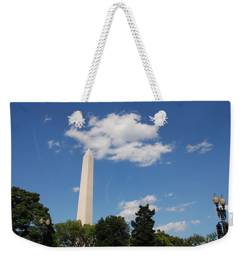 Washington Weekender Tote Bag featuring the photograph Obelisk Rises Into the Clouds by Kenny Glover