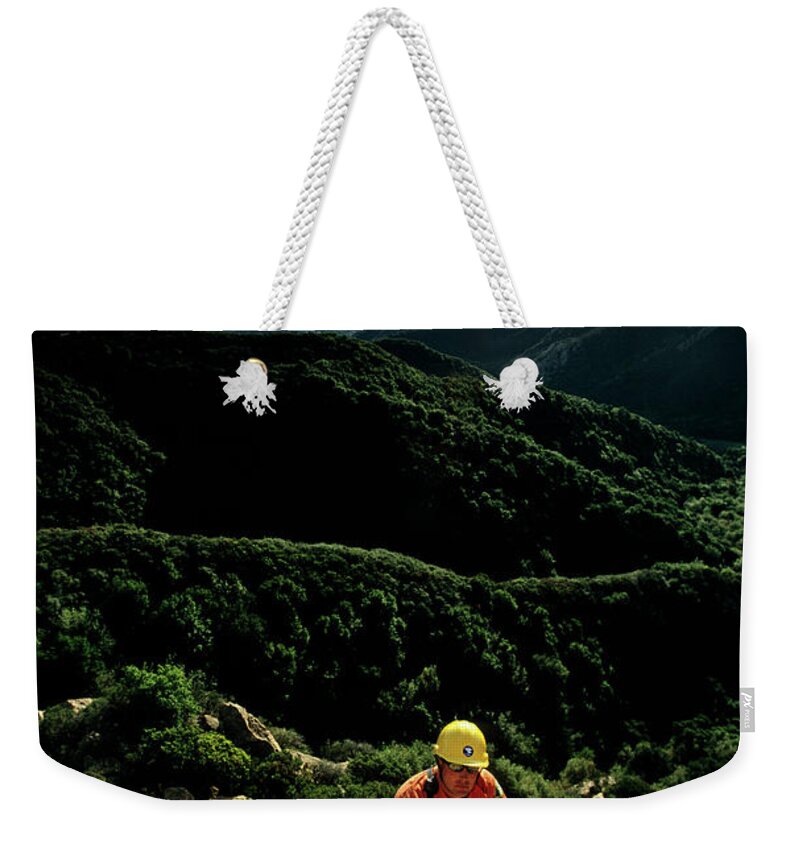 30s Weekender Tote Bag featuring the photograph Search And Rescue Climber Tending Body #1 by Kevin Steele