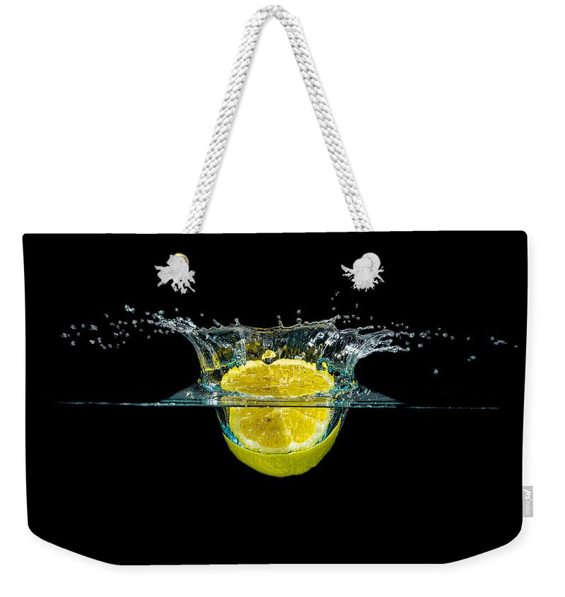 Beverage Weekender Tote Bag featuring the photograph Splashing Lemon #1 by Peter Lakomy