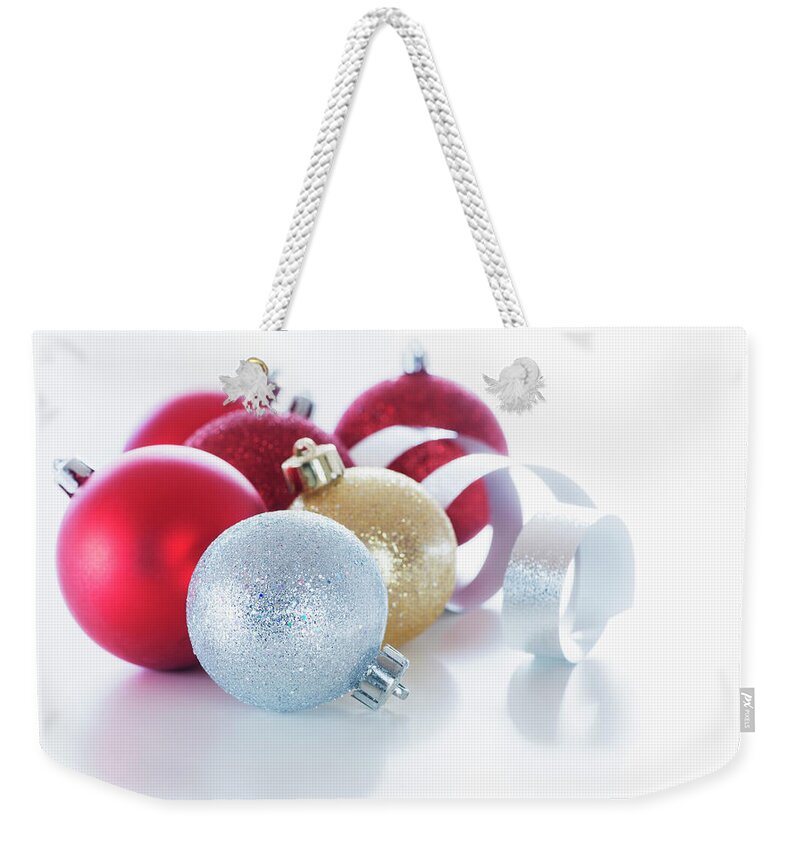 White Background Weekender Tote Bag featuring the photograph Studio Shot Of Christmas Ornaments #1 by Daniel Grill