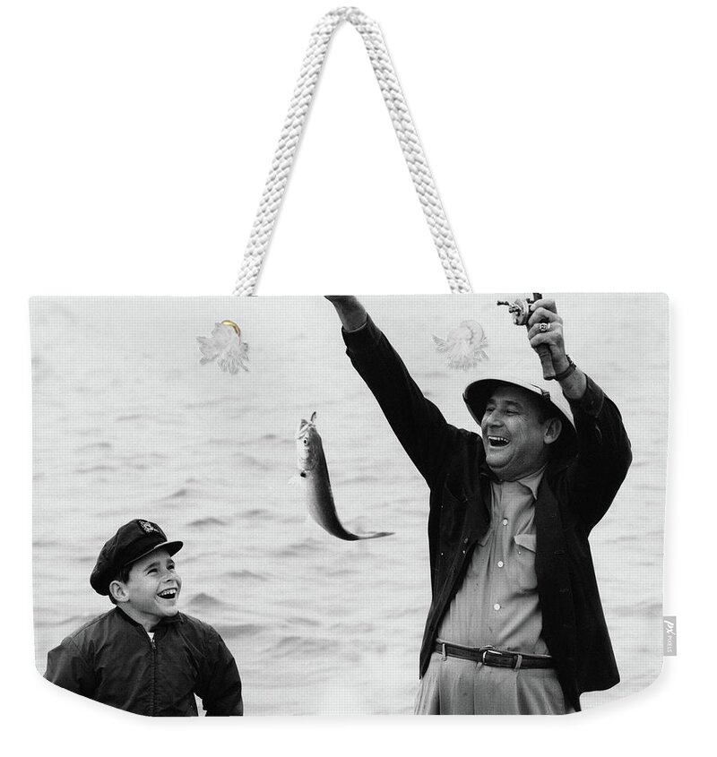 Photography Weekender Tote Bag featuring the photograph 1950s 1960s Boy Son Fishing With Man by Vintage Images