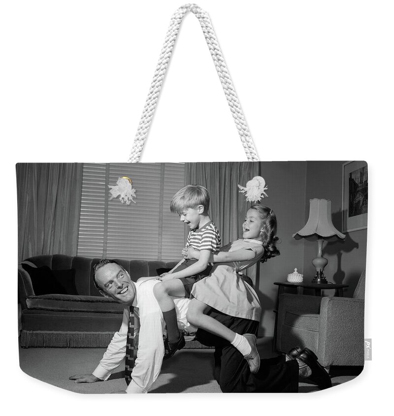 Photography Weekender Tote Bag featuring the photograph 1950s 1960s Dad Carrying Boy & Girl by Vintage Images
