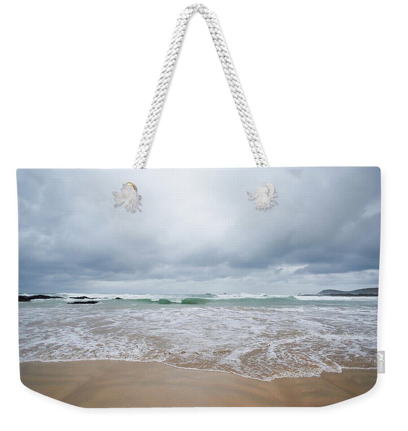 Water's Edge Weekender Tote Bag featuring the photograph Waves Crashing At Beach #2 by Dougal Waters