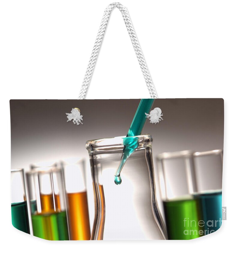 Chemical Weekender Tote Bag featuring the photograph Laboratory Experiment in Science Research Lab #3 by Olivier Le Queinec