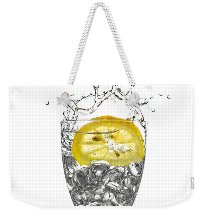 Alcohol Weekender Tote Bag featuring the photograph Slice of lemon in Glass #6 by Peter Lakomy