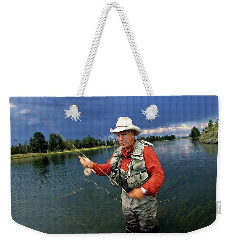 A Man In A Cowboy Hat Fly Fishing Weekender Tote Bag by Dawn Kish