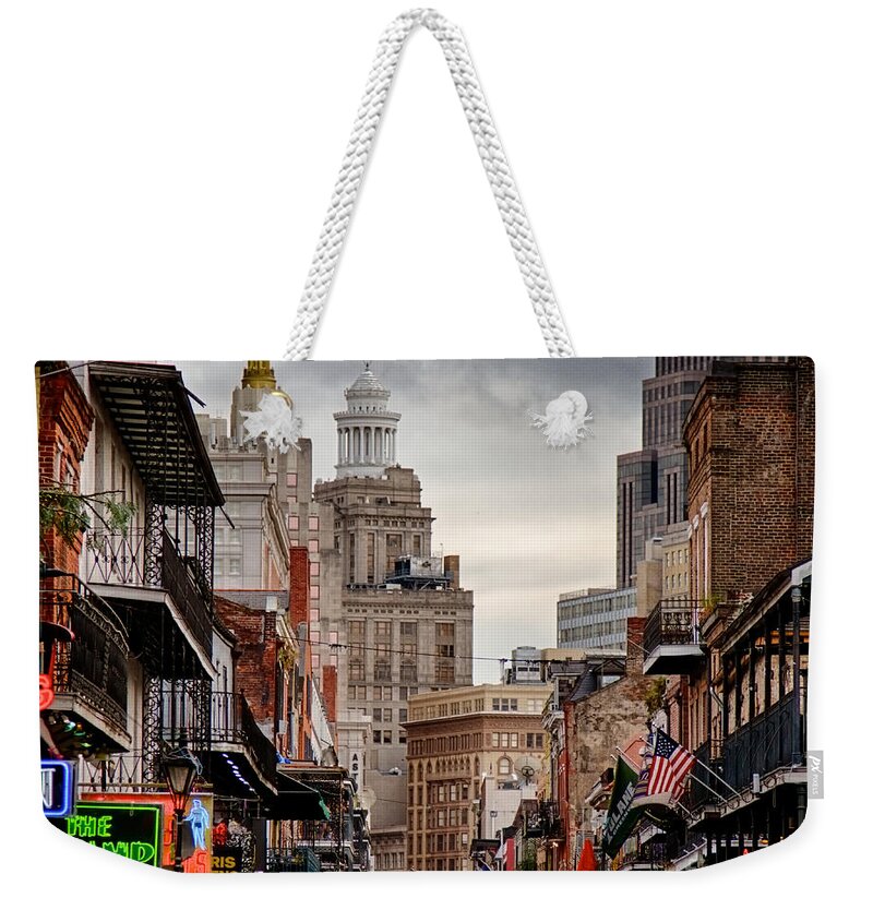 New Orleans Weekender Tote Bag featuring the photograph A view down Bourbon Street by Jarrod Erbe
