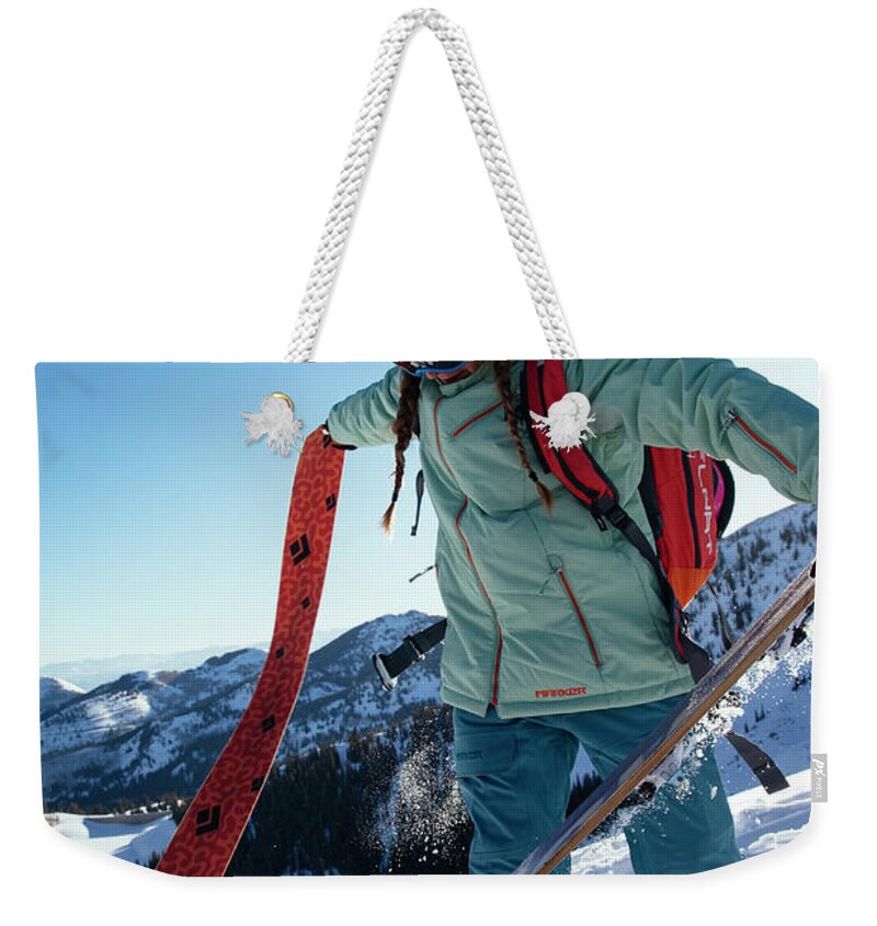 Day Weekender Tote Bag featuring the photograph A Woman Backcountry Skiing by Mike Schirf