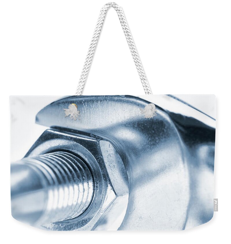 White Background Weekender Tote Bag featuring the photograph A Wrench Turning A Nut Onto A Bolt by Robert George Young