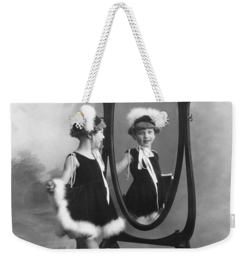 1035-692 Weekender Tote Bag featuring the photograph A Young Girl In A Mirror by Underwood Archives