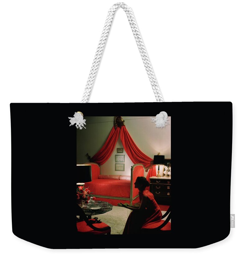 A Young Woman Sitting In A Red Bedroom Weekender Tote Bag