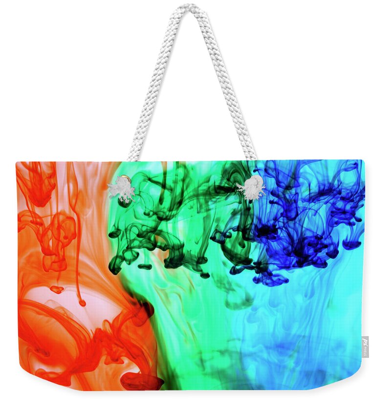 Tranquility Weekender Tote Bag featuring the photograph Abstract Colored Dye In Water by Thomas J Peterson