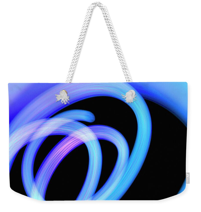 Black Background Weekender Tote Bag featuring the photograph Abstract Spiral Of Blue Fiber Optic by Steven Puetzer